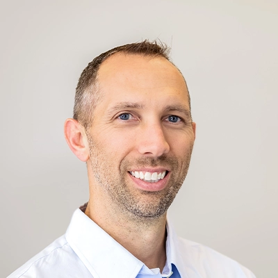Chiropractor John Davis In Dress Shirt Smiling